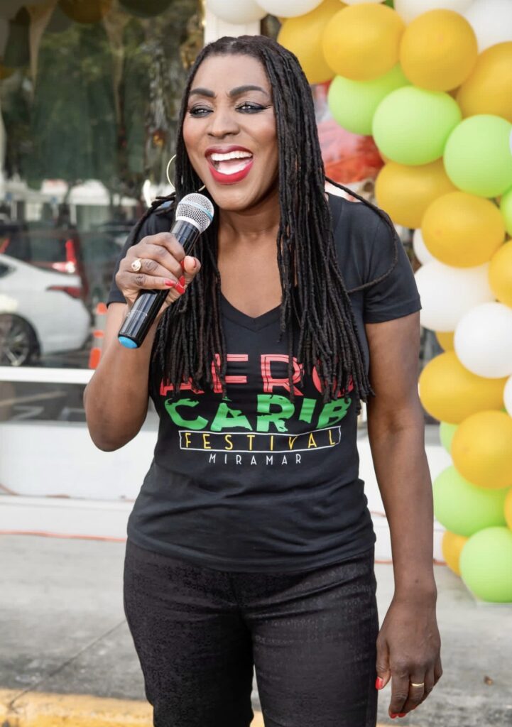 commissioner-wearing--black-tshirt-with-afrocarib-logo-and-black-jeans-logo